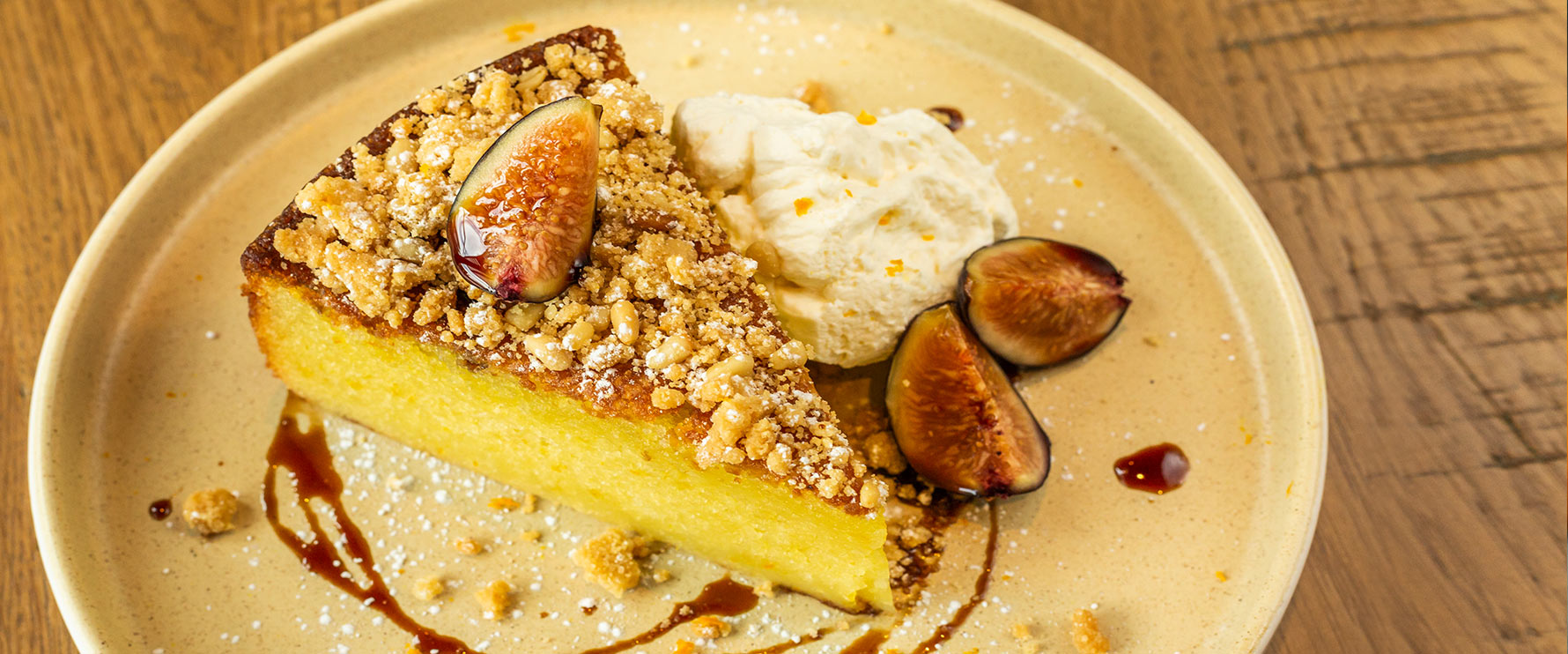 Slice of Olive Oil Cake with seasonal fruit, whipped mascarpone and saba.