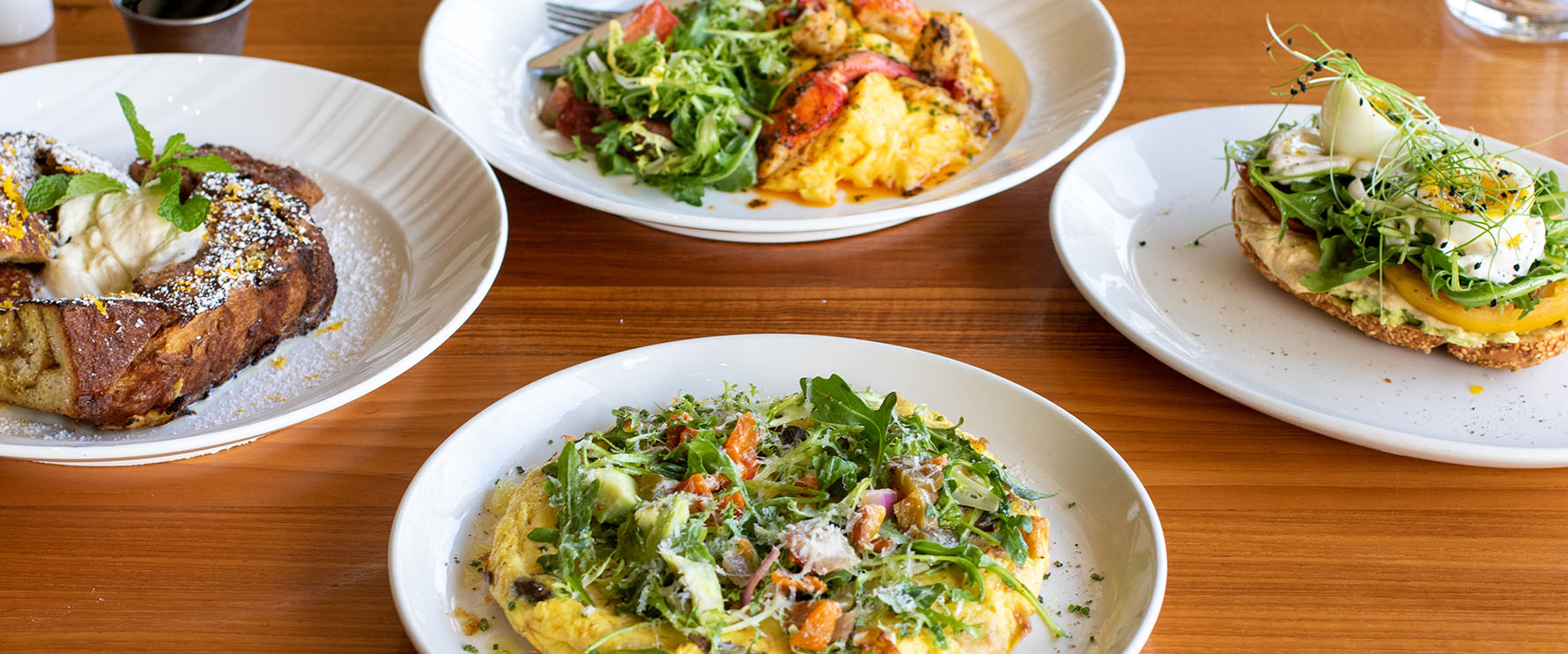 Several brunch dishes from Del Mar, Naples plated on a table.