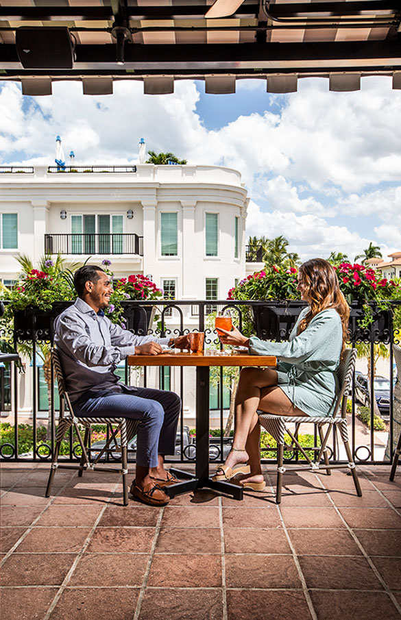 Couple dining on the terrace at Del Mar Naples