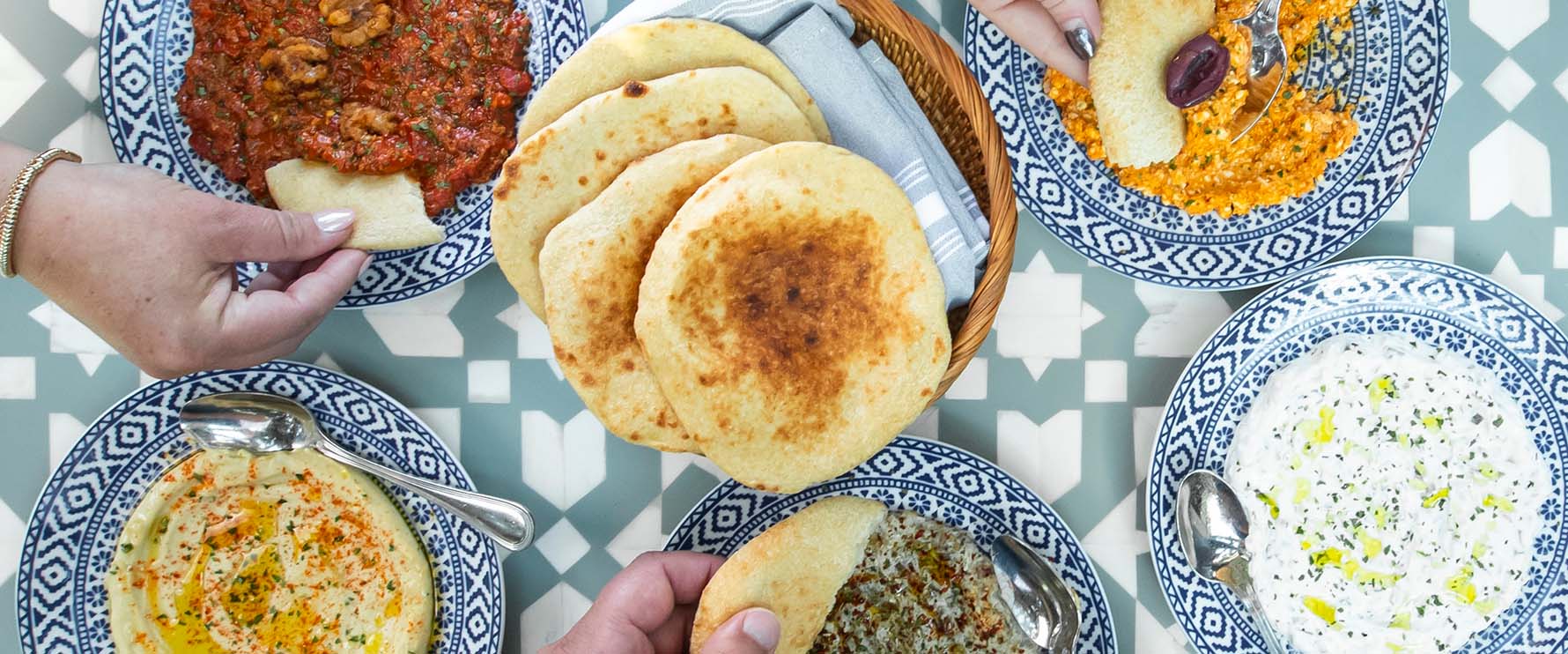 Close up of a large spread of mediterranean food from Del Mar Naples.